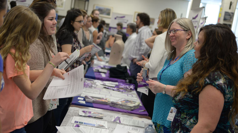 A picture of people meeting each other at a career fair.